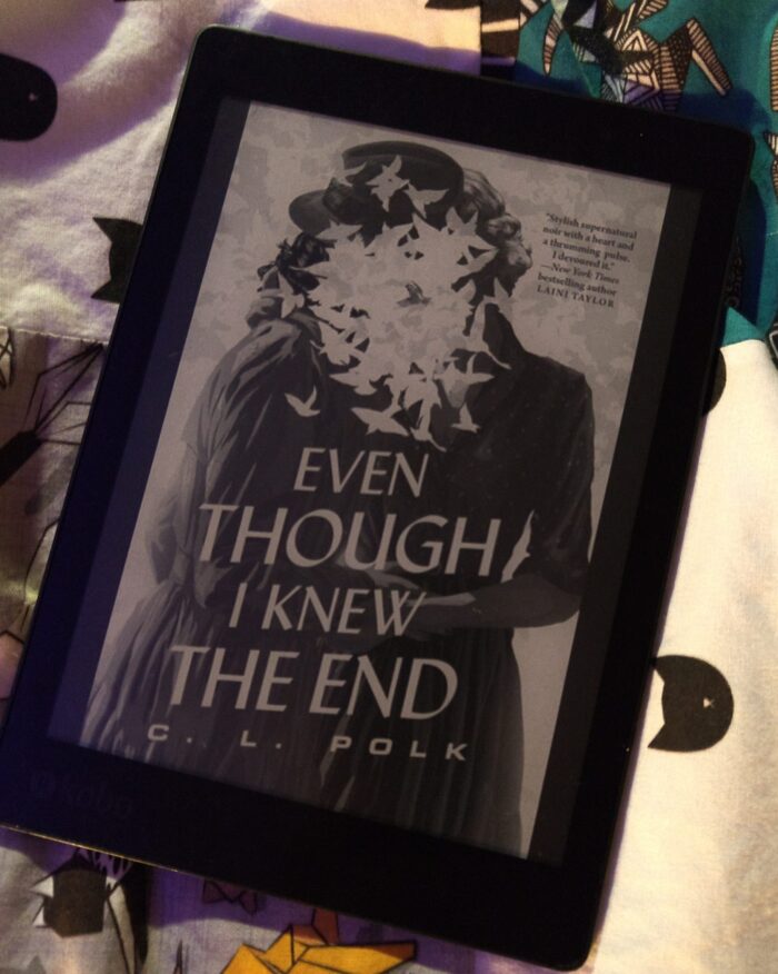 Book cover for Even though I Knew the End, shown in greyscale on kobo ereader. The cover features an illustration of two women with their heads together, but their faces are obscured by birds
