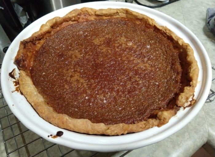 a custardy maple pie in a pie dish, the top has a creme-brulee-ish texture
