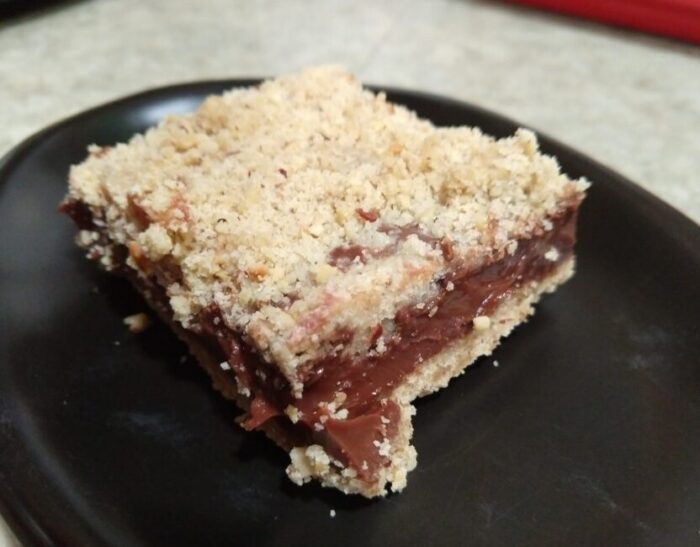 a chocolate hazelnut bar. There's a thick layer of creamy chocolate between a hazelnut crust and crumbly topping
