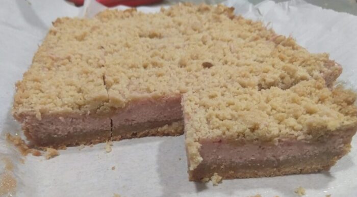 creamy strawberry bars, consisting of a crumbly top over a creamy strawberry filling on a pastry-ish base