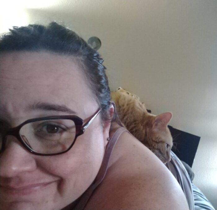 Fritz the cat lounging on my back. I'm lying on my stomach and taking the photo over my shoulder