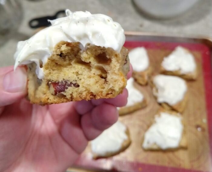 in the foreground, a close-up of the inside of a scone. The rest of the scones on a pan in the background