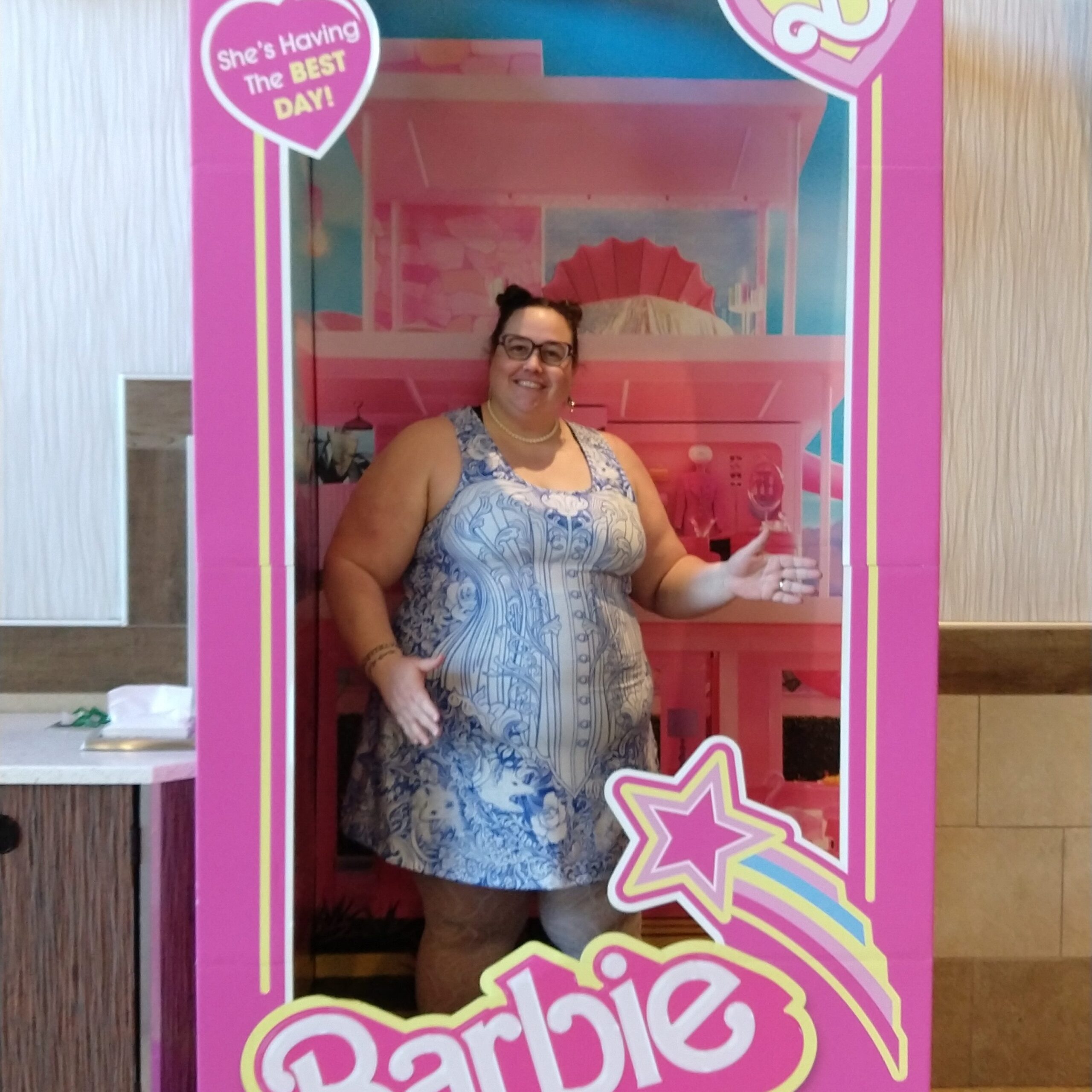 me, dressed up and posing in the Barbie doll box at the movie theater