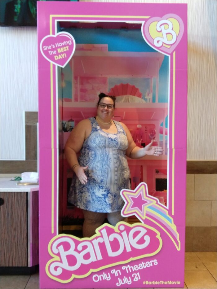 me, dressed up and posing in the Barbie doll box at the movie theater