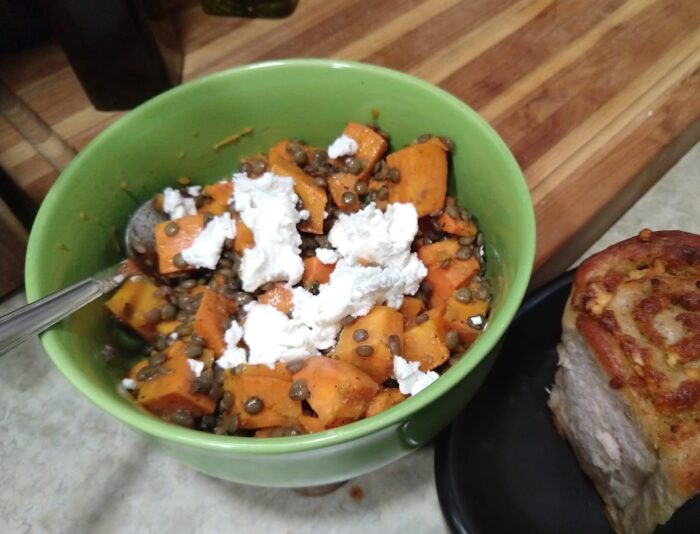 a bowl of sweet potatoes and lentils topped with goat cheese