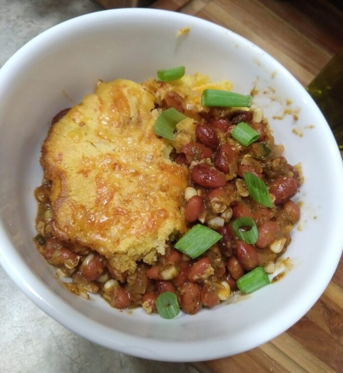 a bowl of vegetarian tamale pie topped with green onions