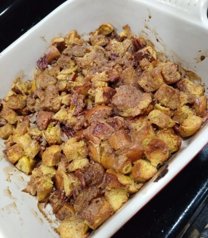 a french toast casserole made with pumpkin rolls and pecans
