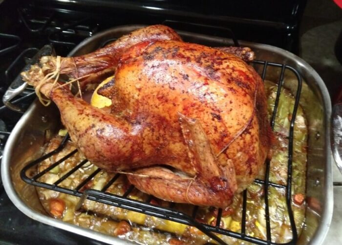 a turkey fresh out of the oven sitting in the roasting pan