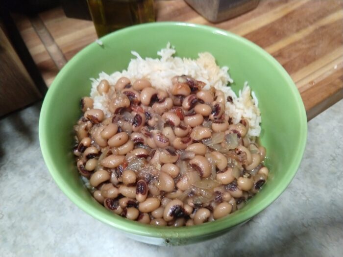 a bowl of black-eyed peas over rice