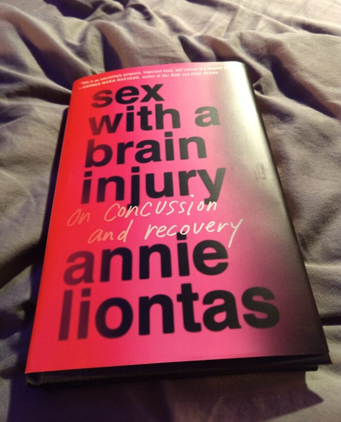 hardback book: Sex with a Brain Injury. Cover is mostly blocky text over a red and black gradient