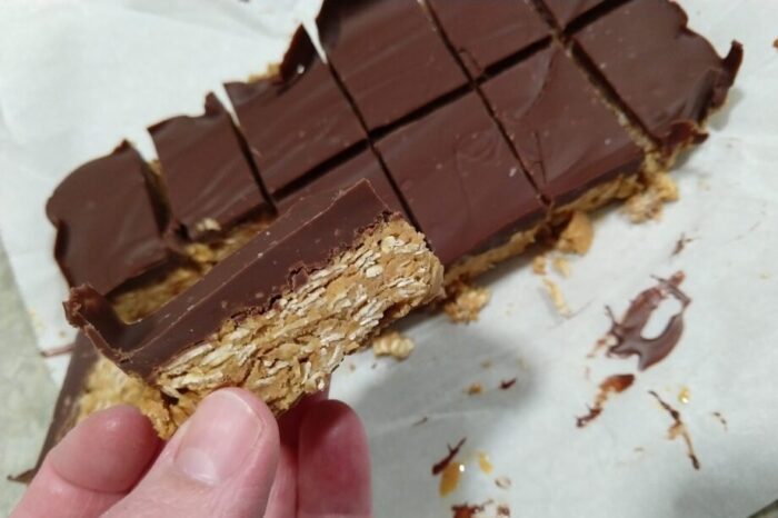 A batch of no-bake peanut butter and oat bars topped with chocolate