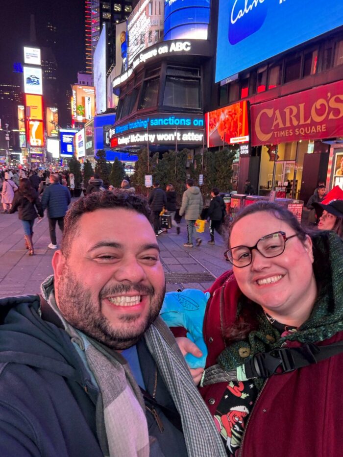 Lito and I smiling at the camera with Times Square stretching out behind us