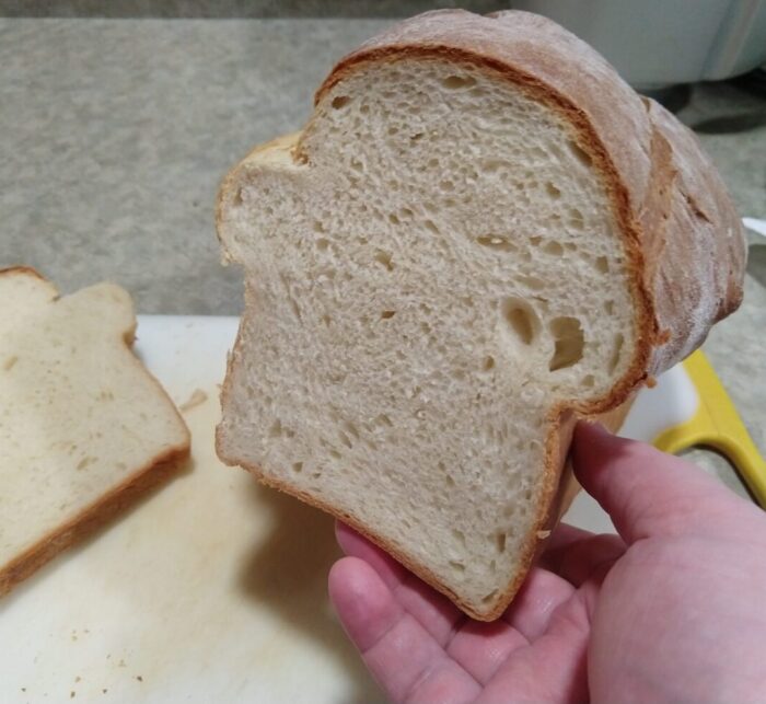 Cross-section of a loaf of bread. White on the inside with a good-looking crumb