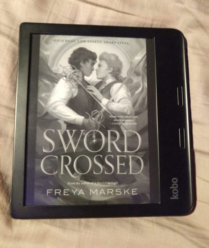 book cover for Sword Crossed shown in grey scale on kobo ereader