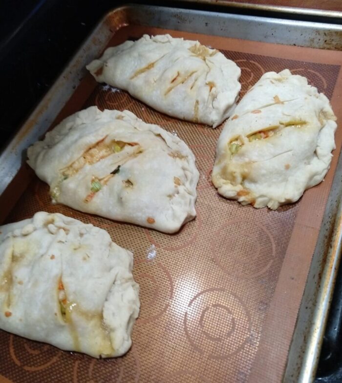 a sheet pan of four rather ill-formed pasties