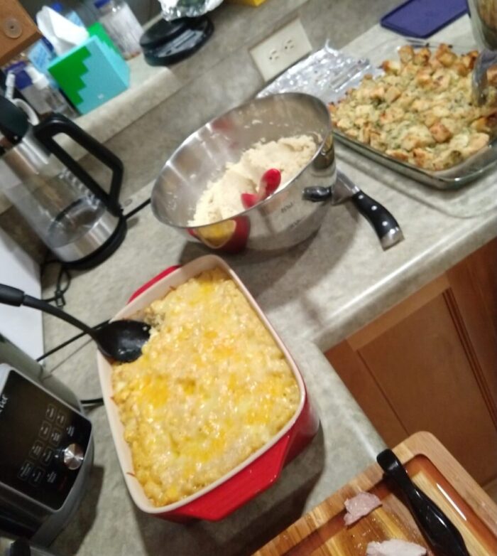 buffet presentation of mashed potatoes, stuffing, and macaroni and cheese