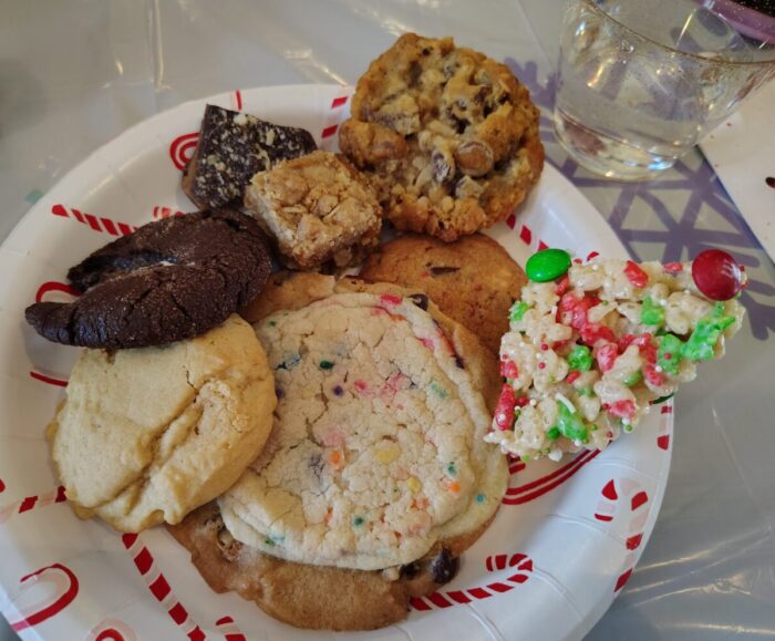 an unreasonable amount of different holiday cookies and treats for one person on a plate