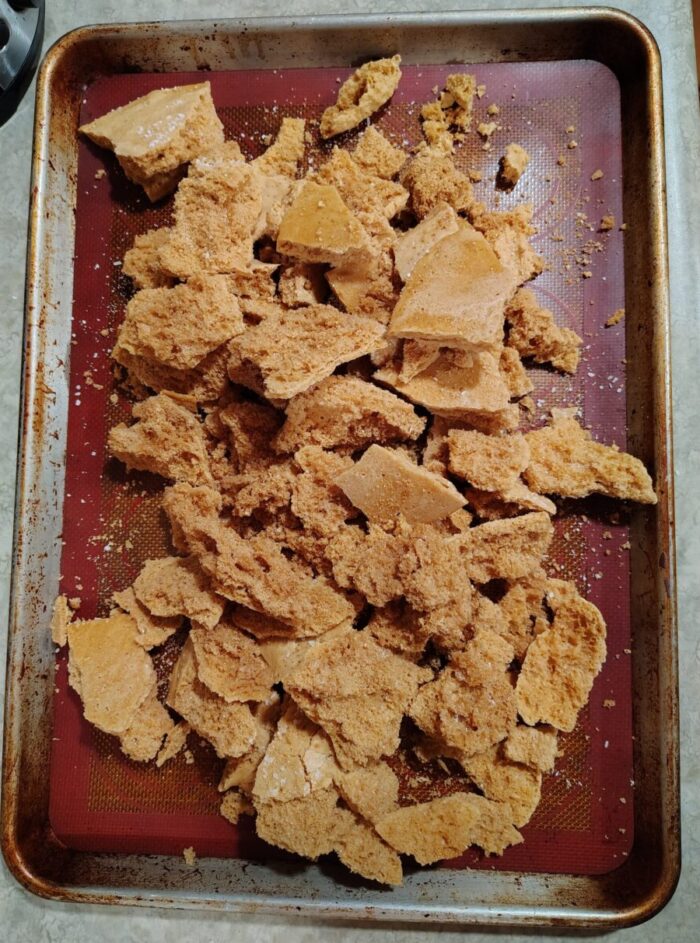 a sheet pan of honeycomb broken up into chunks