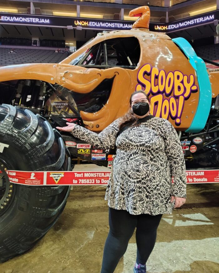 me standing in front of a Scooby Doo-themed monster truck at Monster Jam