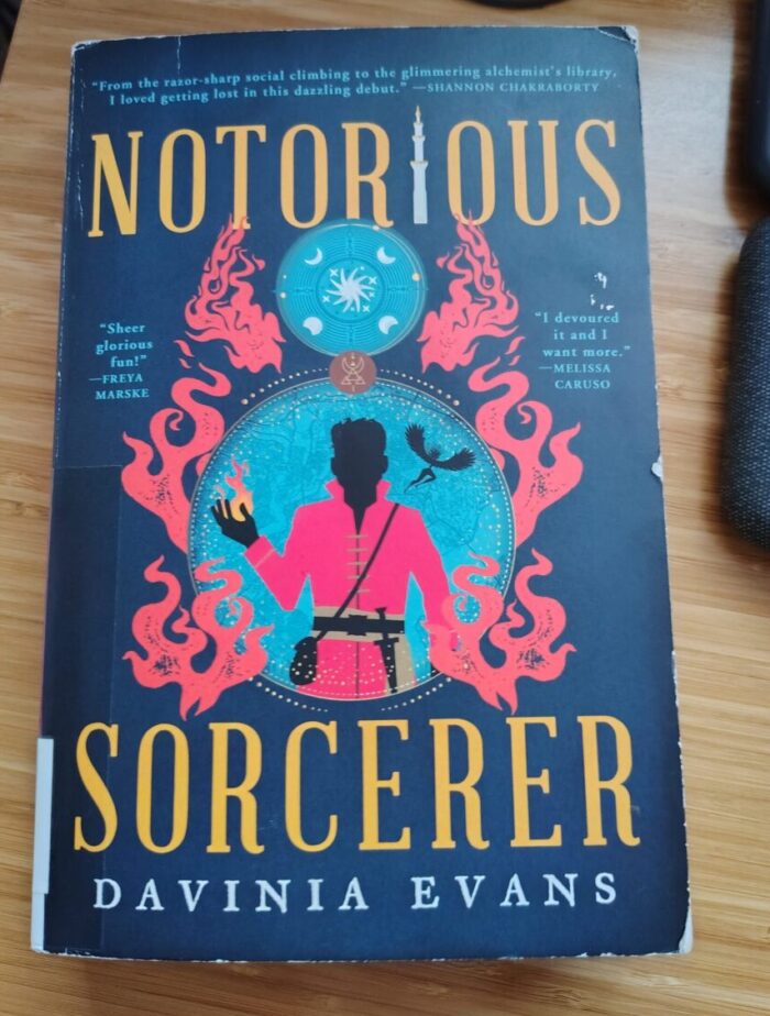 book: Notorious Sorcerer. Cover features the silhouette of a man in a red coat, holding a flame in his hand