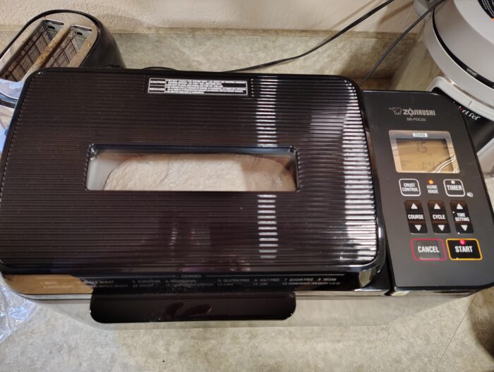 Zojirushi bread machine, a rising loaf is visible through its window