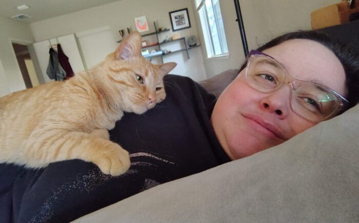 I'm lying on my side and Fritz is lying on top of me. He's gazing lovingly at my face