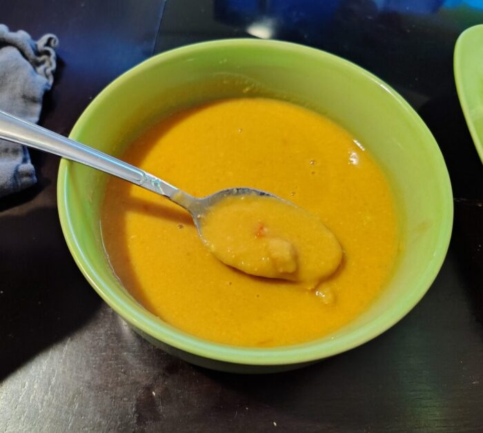 A bowl of mostly smooth Tunisian chickpea soup with a few whole chickpeas visible