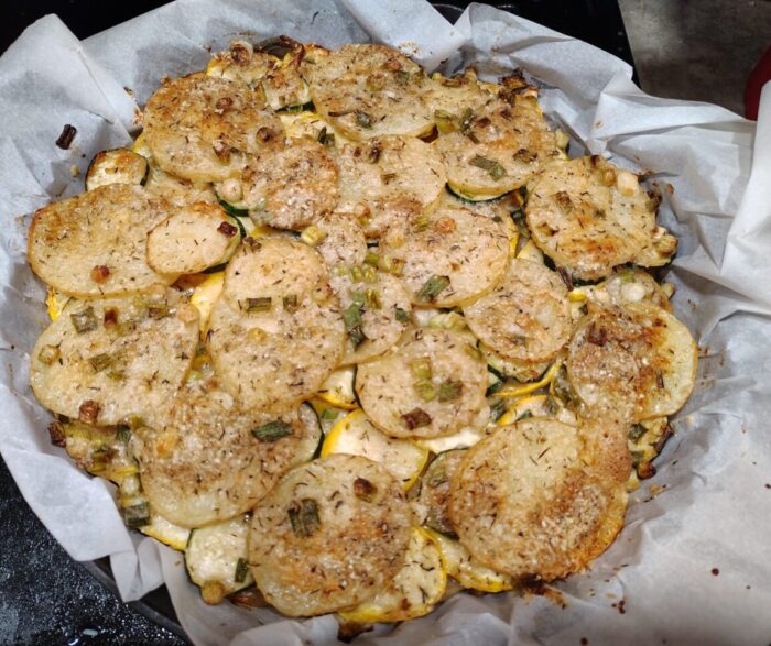 a big, round, skillet-sized herbed summer squash and potato tart, with thin slices of potatoes and squash topped in parmesan and green onions