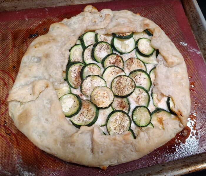 galette with rounds of zucchini piled on top of a ricotta cheese mixture