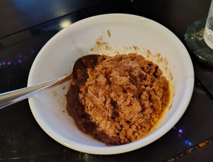 A bowl of unappetizing-looking shaved ice made from frozen chocolate milk