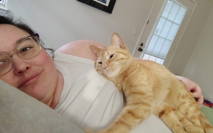 Fritz the cat laying on top of me and giving me a look of love