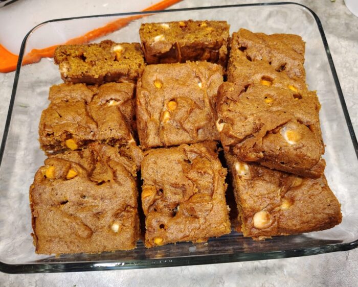 a container filled with bars of pumpkin blondies
