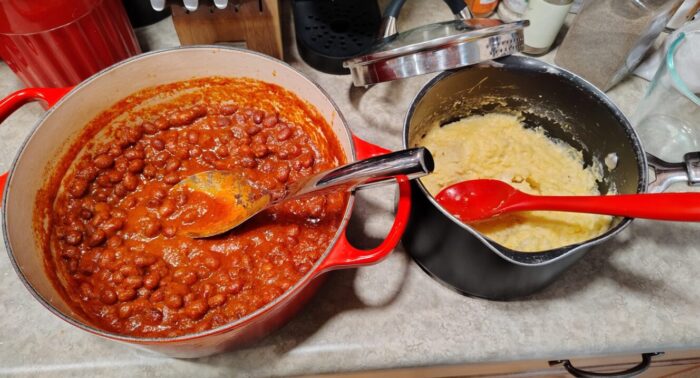 a big pot of beans in tomato sauce and a smaller pot of polenta