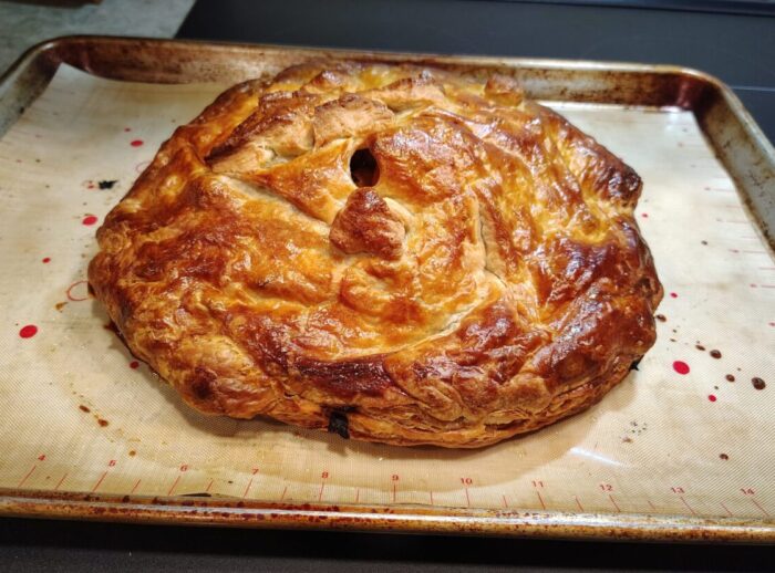big-ass and beautifully glossy puff pastry bake on a baking sheet