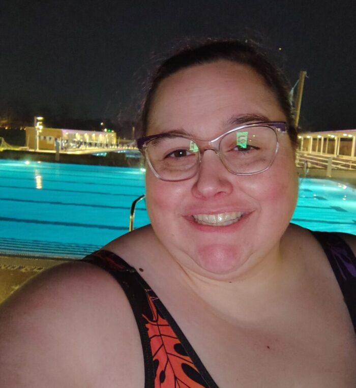 Me in a swimsuit out at the public pool at night before my class