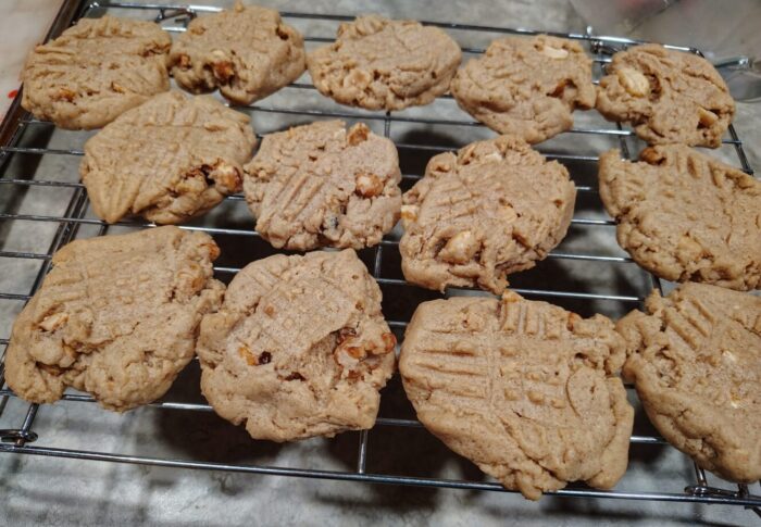 peanut butter cookies cooking on a wire rack