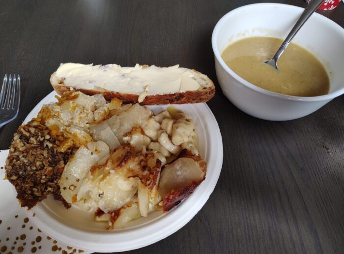 a plate of at least five types of potato dish alongside a bowl of soup