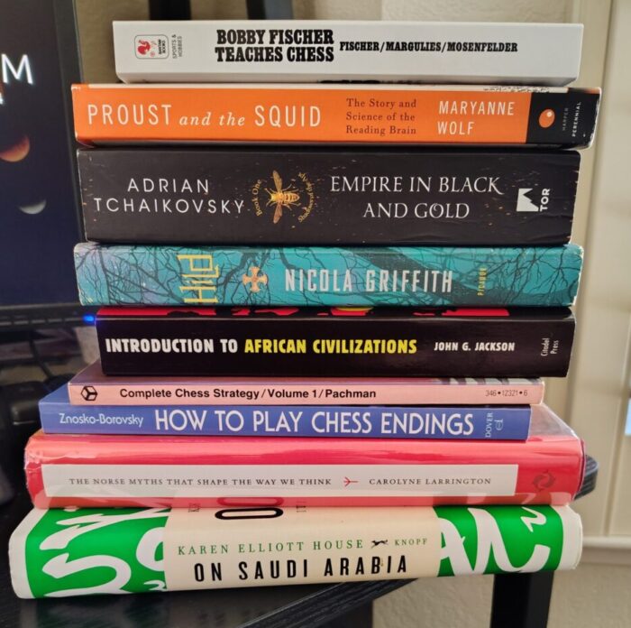 a pile of books including a few books on chess, some novels, one about norse mythology, and "introduction to african civilizations"