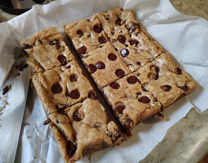 a square batch of cookie bars absolutely loaded with mini peanut butter cups