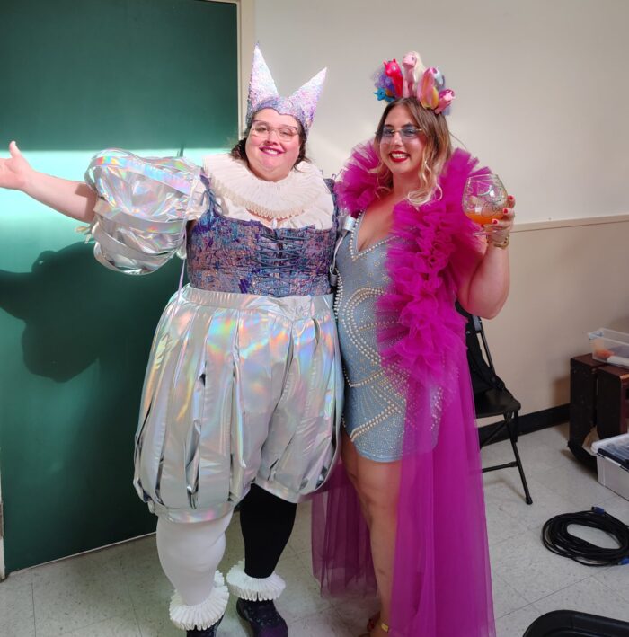 me and Kira dressed fancifully for her party. I'm in a shiny, irridescent jester outfit and she's got a pink tulle duster on and a tiara made out of My Little Ponies