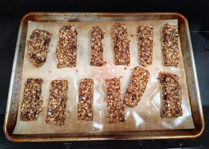 a batch of granola bars spread out on a sheet pan