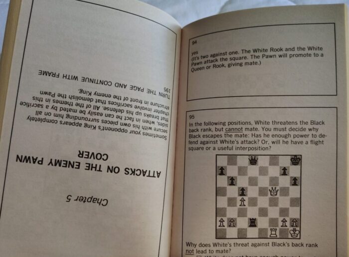 From Bobby Fischer teaches chess. The right page is right-side-up and has an answer for the puzzle on the previous page, then the next puzzle. The left page is upside-down and is the beginning of chapter five.