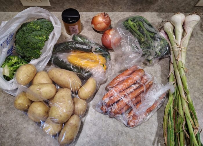 straight from the farmers market: broccoli, potatoes, zucchini, onion, fresh garlic, broccolini, and a jar of honey