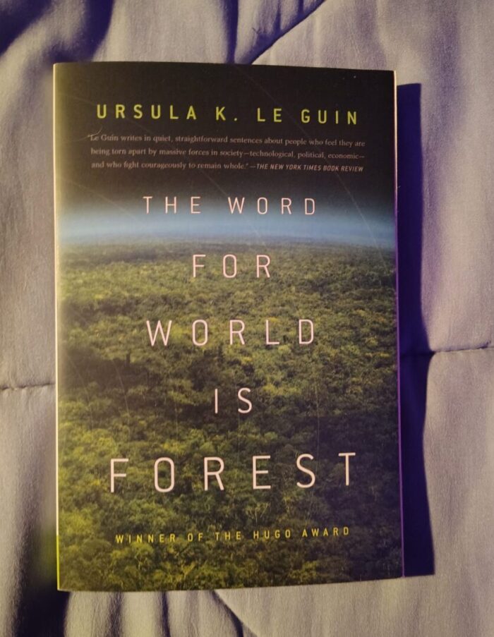 paperback book: The Word for World is Forest. Cover features a dense forest