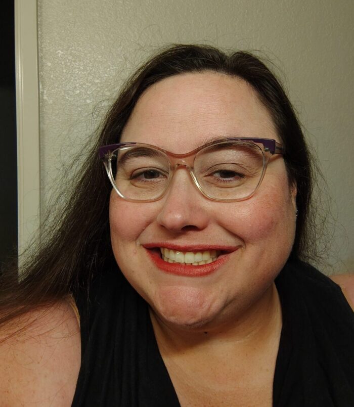 me, smiling at the camera. I am wearing makeup, which I rarely do